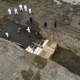 Workers wearing personal protective equipment bury bodies in a trench on Hart Island, just outside of the Bronx in New York on April 9, 2020.